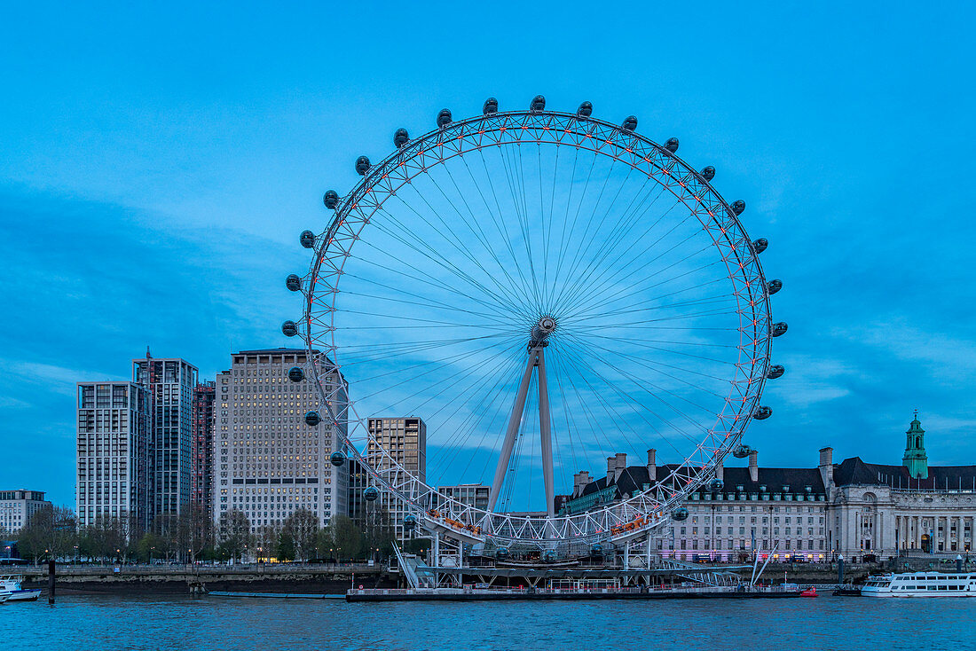 The Eye on South Bank of Thames river, with Shell Building (left) and County Hall (right) in background, London, United Kingdom