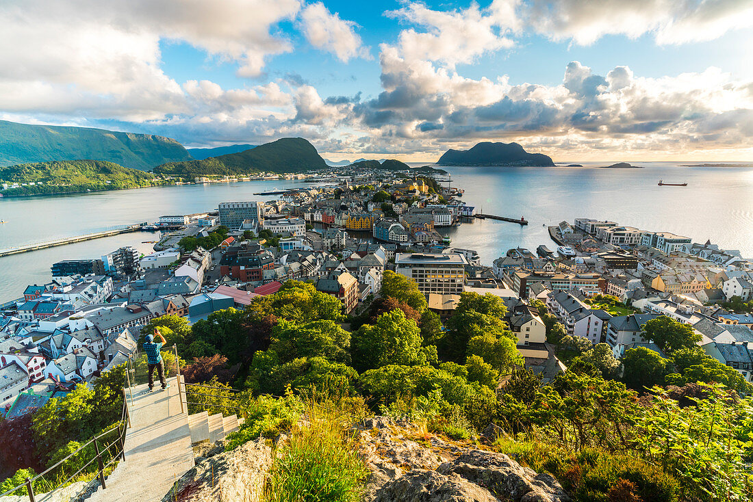 Tourist snaps photos of Alesund from Byrampen viewpoint, More og Romsdal county, Norway