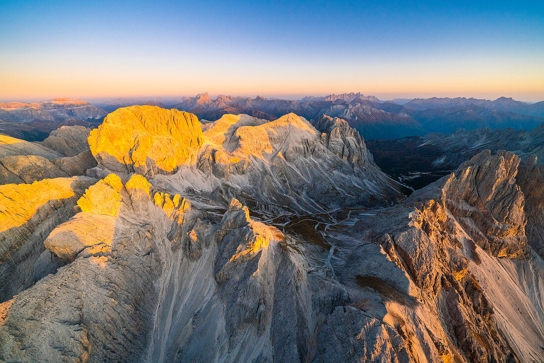 Catinaccio Group lit by warm sunset in autumn, aerial view Sciliar-Catinaccio Natural Park, Dolomites, South Tyrol, Italy