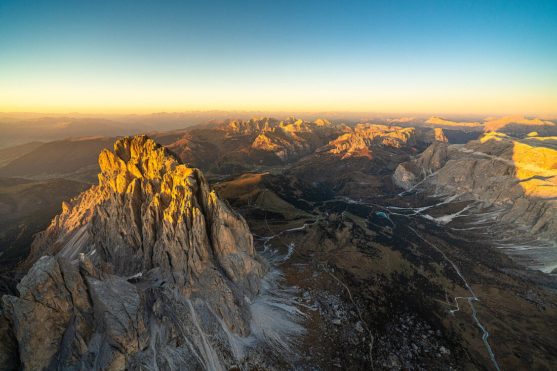 Sunset over Sassolungo and the Odle group in autumn, aerial view, Dolomites, South Tyrol, Italy