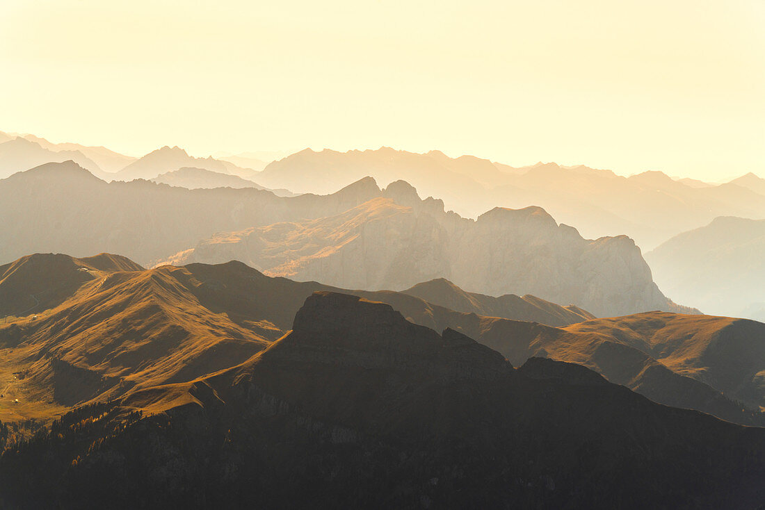 Mountains silhouette of Val di Fassa at sunset in autumn seen from Sass Pordoi, Dolomites, Trentino, Italy