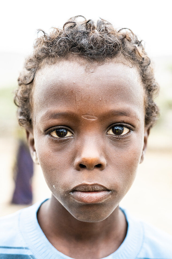 Sad looking boy, Melabday, Asso Bhole, Danakil Depression, Afar Region, Ethiopia, Africa