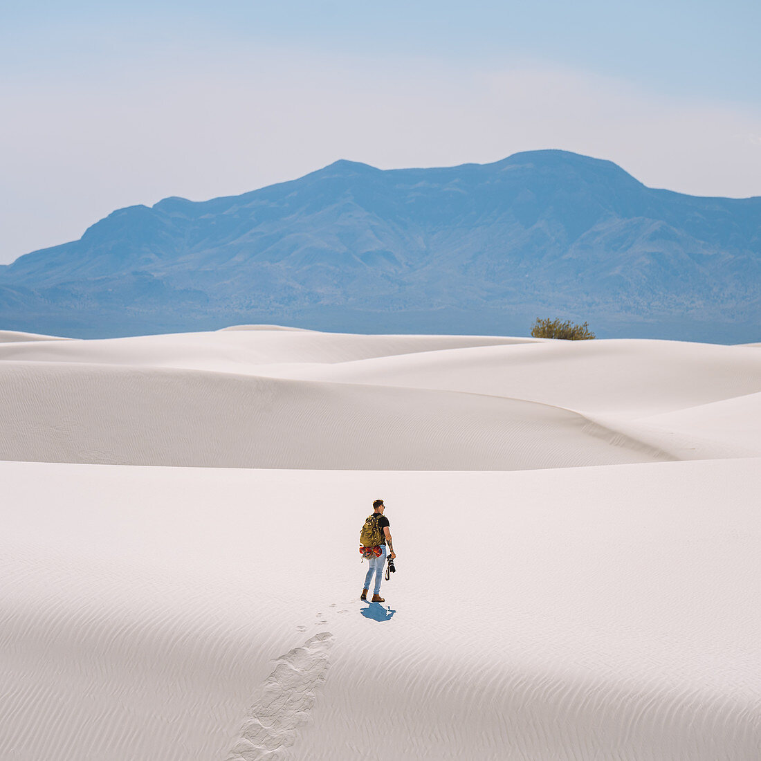 Hiker crossing White Sands National Monument,New Mexico,US
