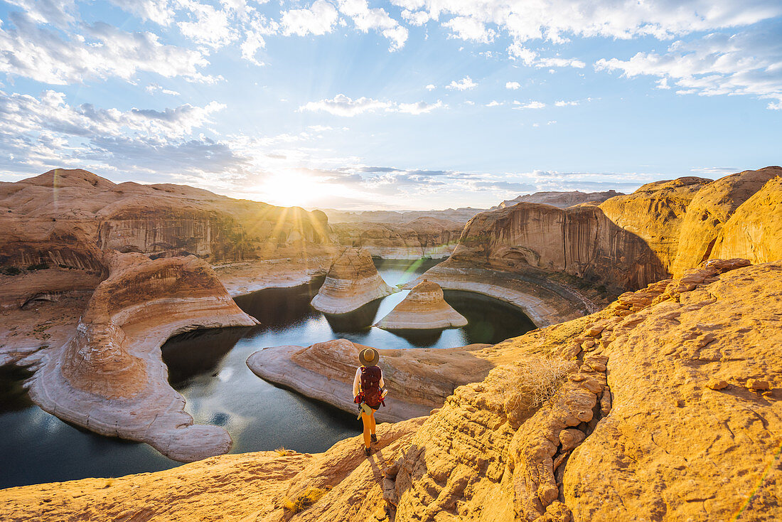 Backpacker at sunrise,Reflection Canyon,Lake Powell,Utah,US