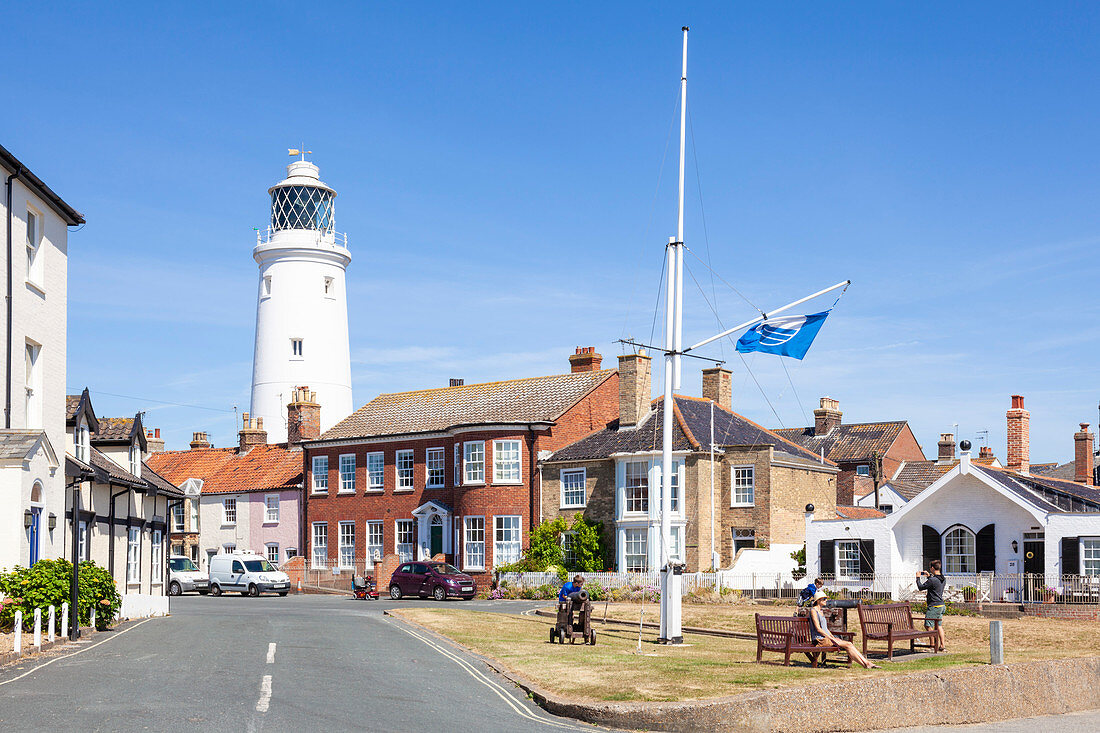 Southwold Lighthouse and houses, with people on a bench, St. James Green, East Cliff, Southwold, Suffolk, England, United Kingdom, Europe