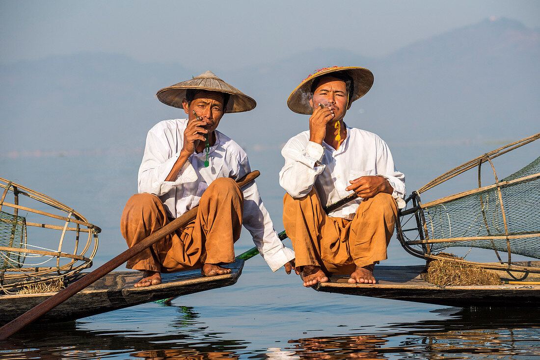 Two Intha leg rowing fishermen smoking cigars, Inle Lake, Shan State, Myanmar (Burma), Asia