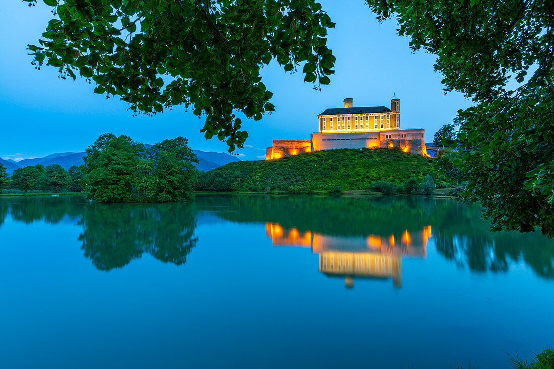 View of Trautenfels Castle reflected in nearby lake at dusk, Styria, Austria, Europe