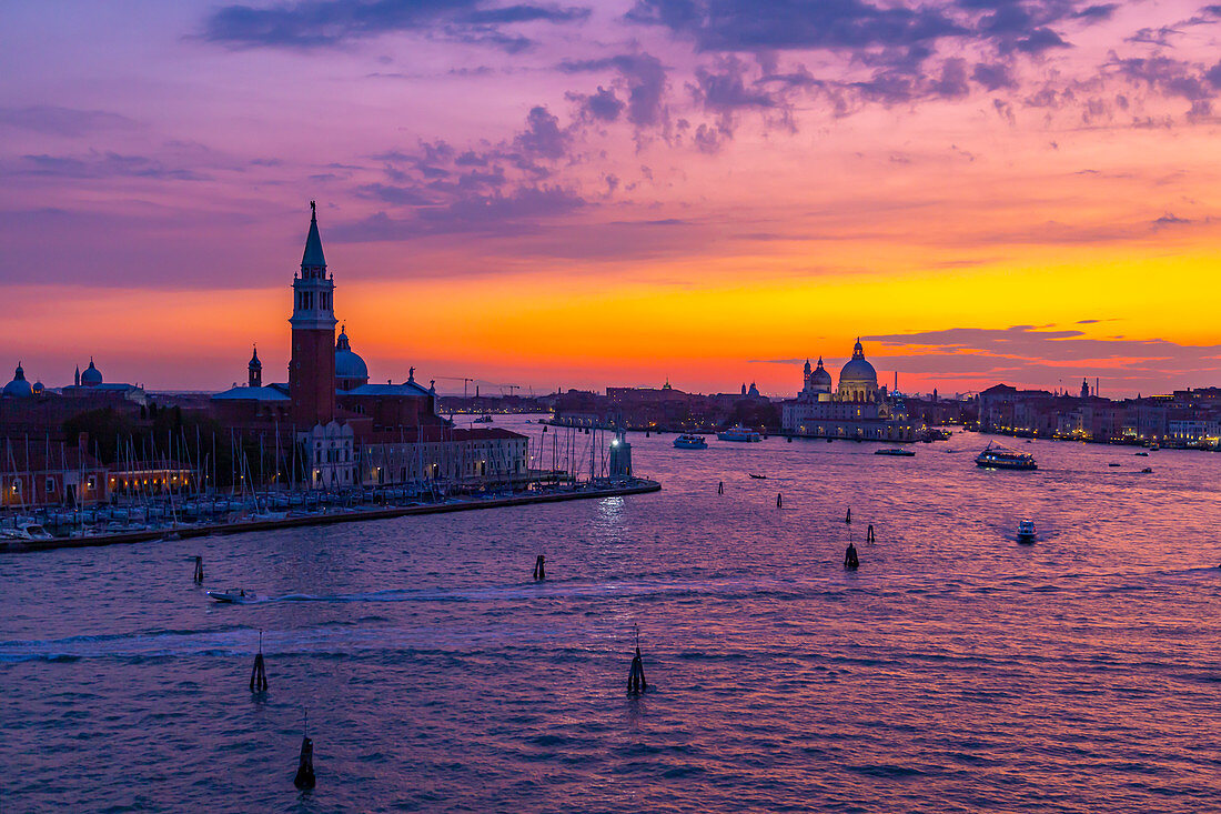 View of Venice skyline and red sky from cruise ship at dusk, Venice, UNESCO World Heritage Site, Veneto, Italy, Europe
