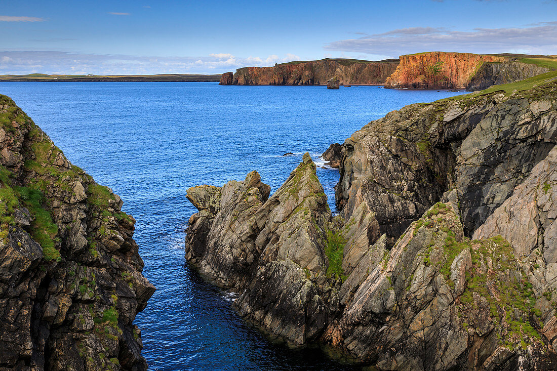 Ness of Hillswick, dramatic jagged cliffs, and red granite cliffs of The Heads of Grocken, Northmavine, Shetland Isles, Scotland, United Kingdom, Europe