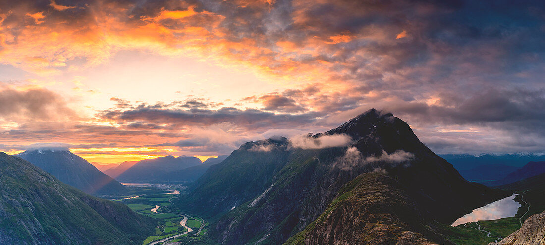 Fiery sky at sunset over Romsdalen and Venjesdalen mountains seen from Romsdalseggen Ridge, Andalsnes, More og Romsdal, Norway, Scandinavia, Europe