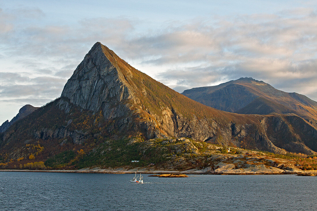 Mountain landscape with fishing boat in the archipelago in front of Oernes, Nordland province, Salten district, Helgeland coast, Norway, Europe