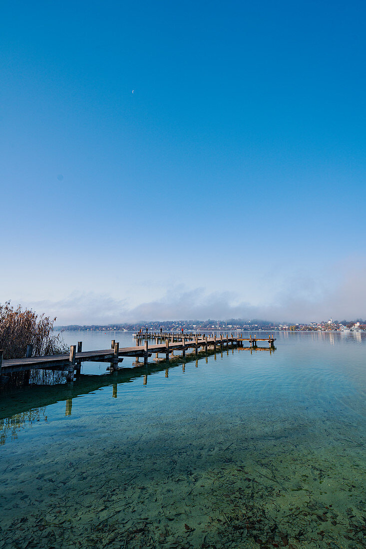 Morning view of the bathing jetty on Lake Starnberg on the bathing beach of Percha, Starnberg, Bavaria, Germany.