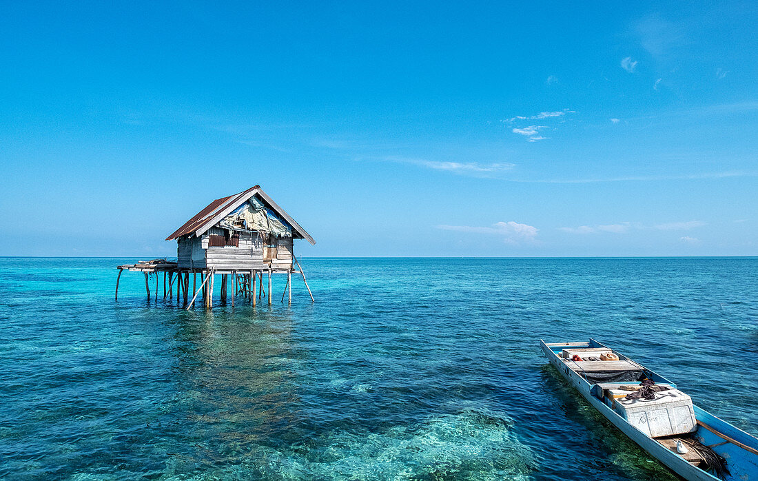 Huts built over the water by the Bajau Fishermen who live there three months of the year, Togian Islands, Indonesia, Southeast Asia, Asia