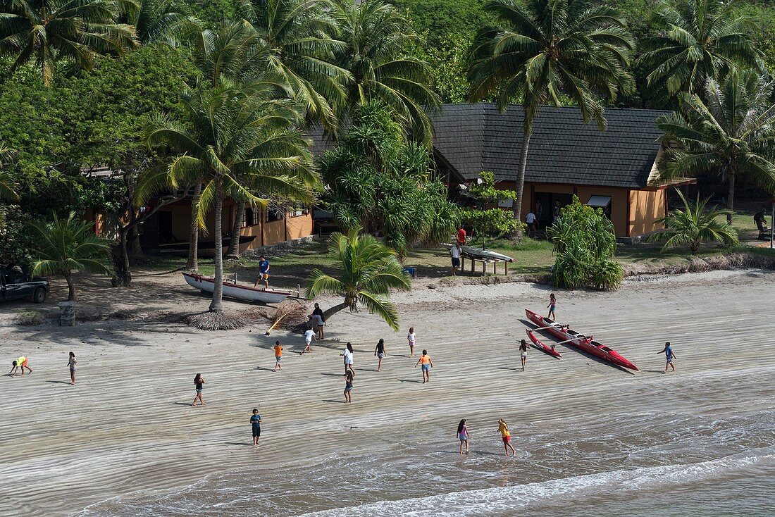 France, French Polynesia, Marquesas archipelago, Ua Pou island, Hakahau, children on the beach, outrigger canoe