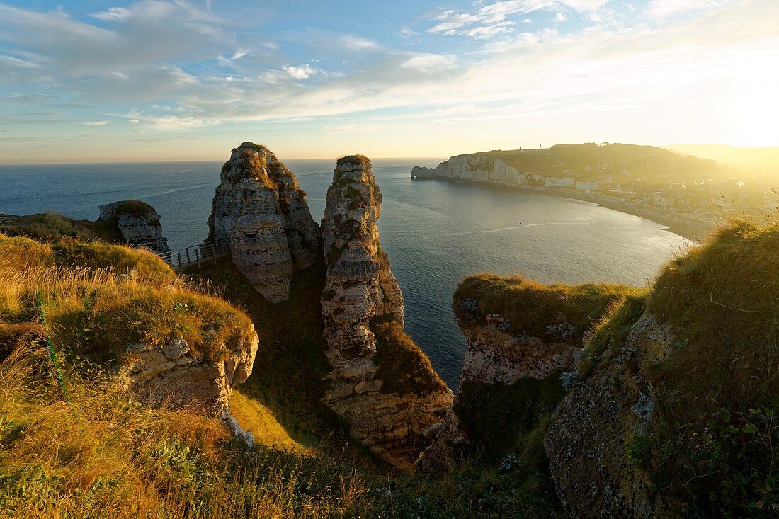 France, Seine Maritime, Pays de Caux, Cote d'Albatre (Alabaster Coast), Etretat and it's beach, Aval cliff and Chambre des Demoiselles with in the background the Amont cliff and Notre Dame de la Garde church