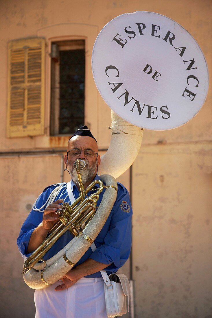 France, Alpes Maritimes, Cannes, Trombonist of the provencal fanfare L'Espérance de Cannes in the old district of the Suquet