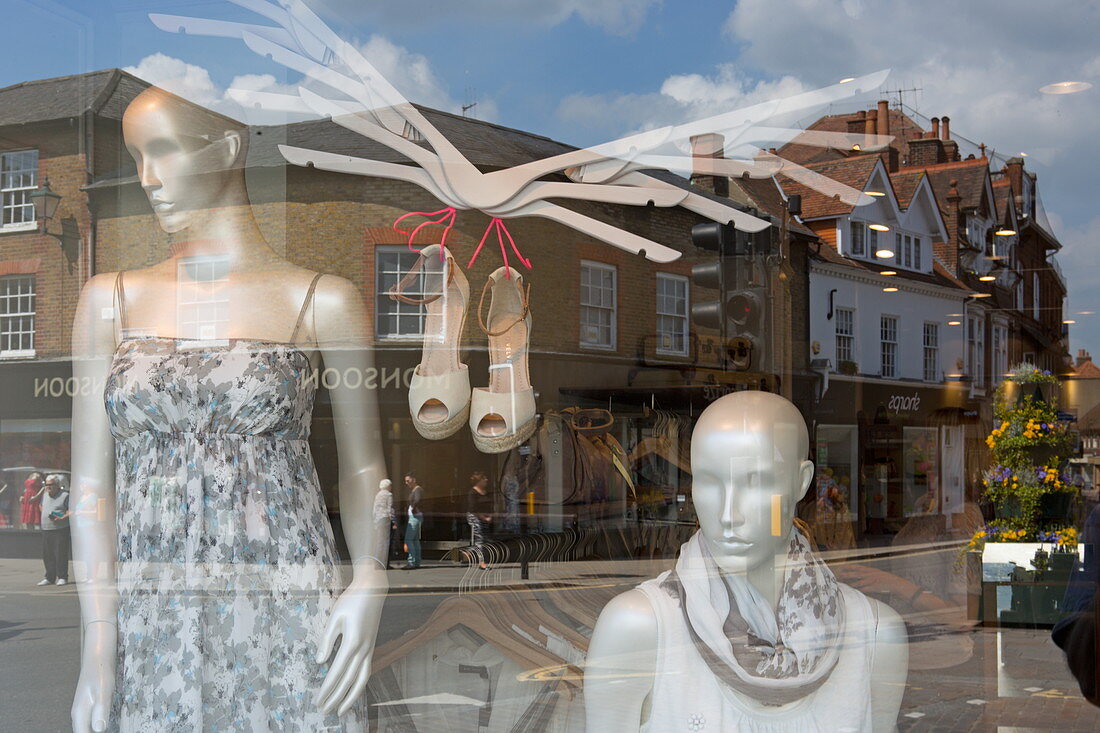 Looking into a shop window with the reflection of houses on Market Place, Henley-upon-Thames, Oxfordshire, England