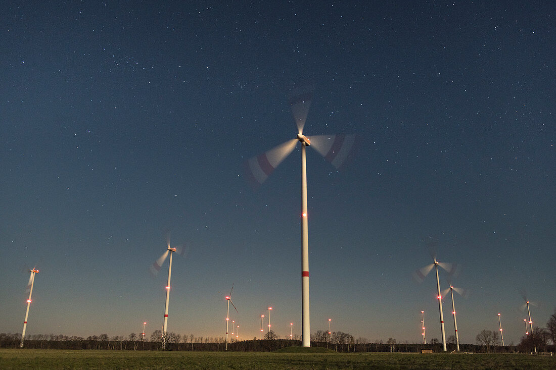 Wind farm in front of starry sky, Germany, Brandenburg,