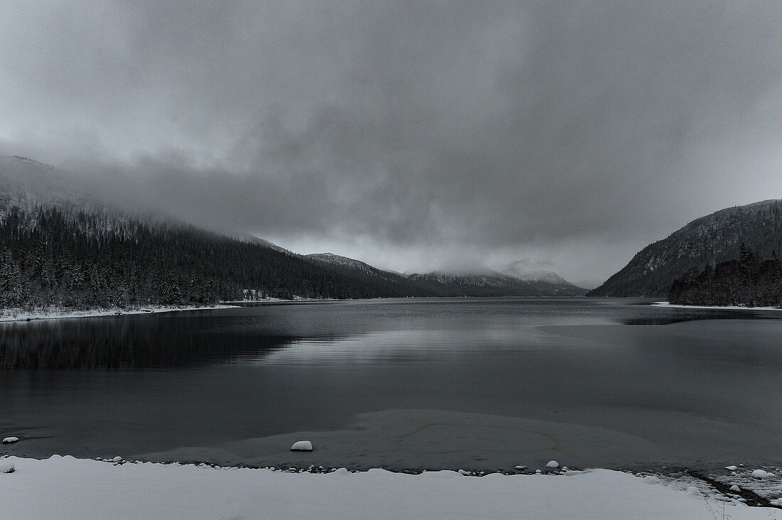 Gloomy winter mood with a view of the mountains and the lake at Storjola, Jämtland, Sweden
