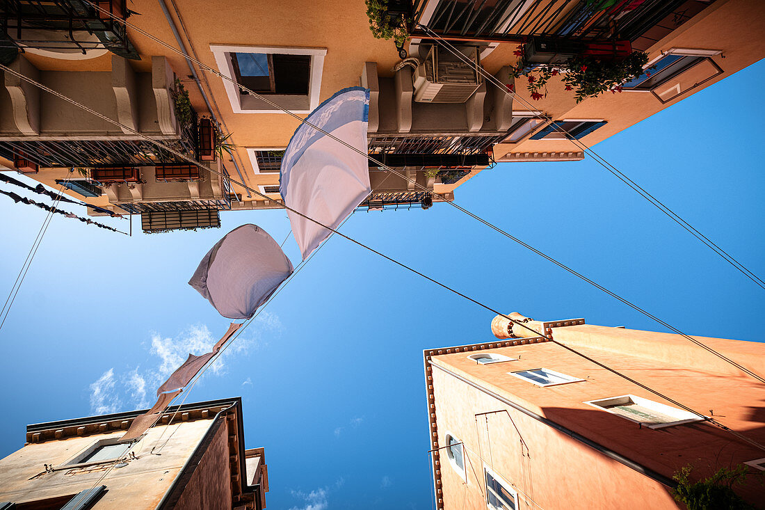 View from below on house facades with clothesline in Cannaregio, Venice, Veneto, Italy, Europe