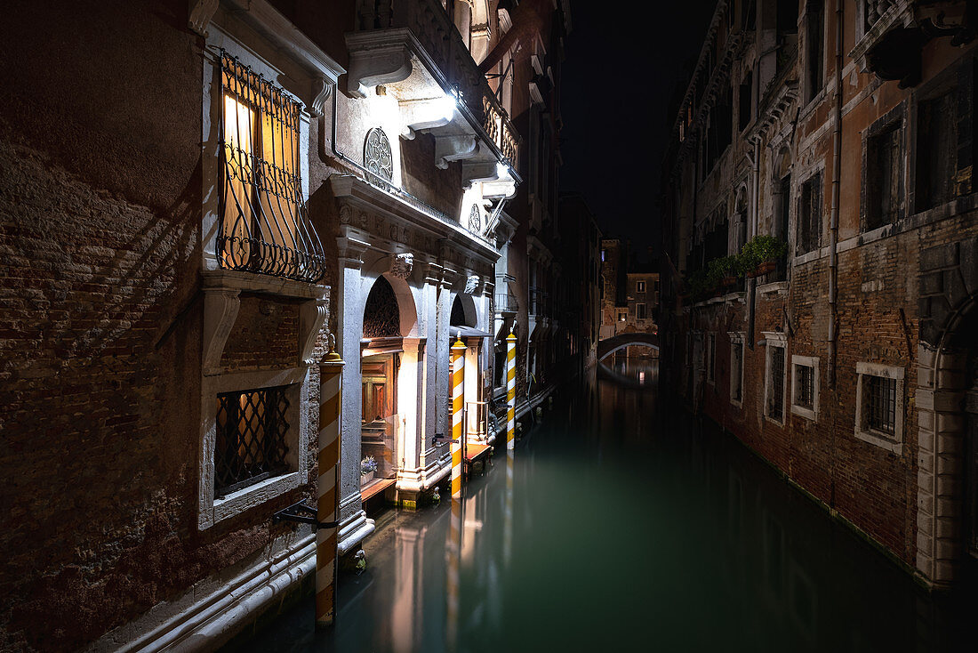 View of Venetian facades at night along a canal in San Marco, Venice, Veneto, Italy, Europe