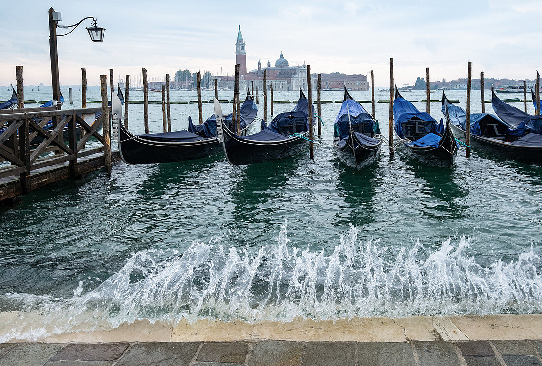 View of the Venetian gondolas on St. Mark's Square with spray, in the background the island of San Giorgio, Venice, Veneto, Italy, Europe
