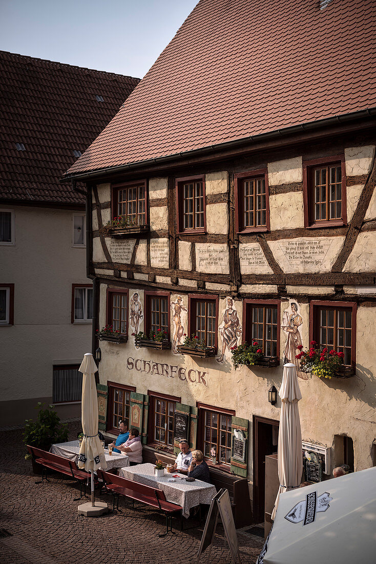 Guests sit in the outdoor area of the historic &quot;Scharfeck&quot; restaurant in Fridingen an der Donau, Baden-Württemberg, Germany