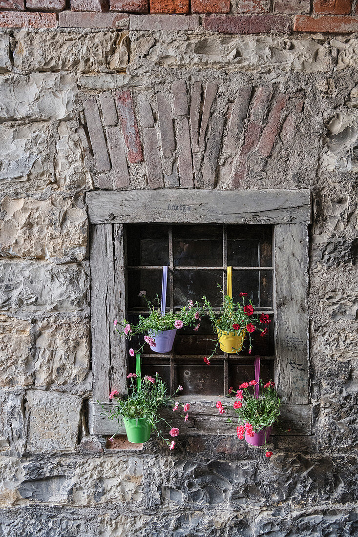 Colorful flower decorations hang on the historic house near the castle in Sigmaringen, Baden-Württemberg, Danube, Germany