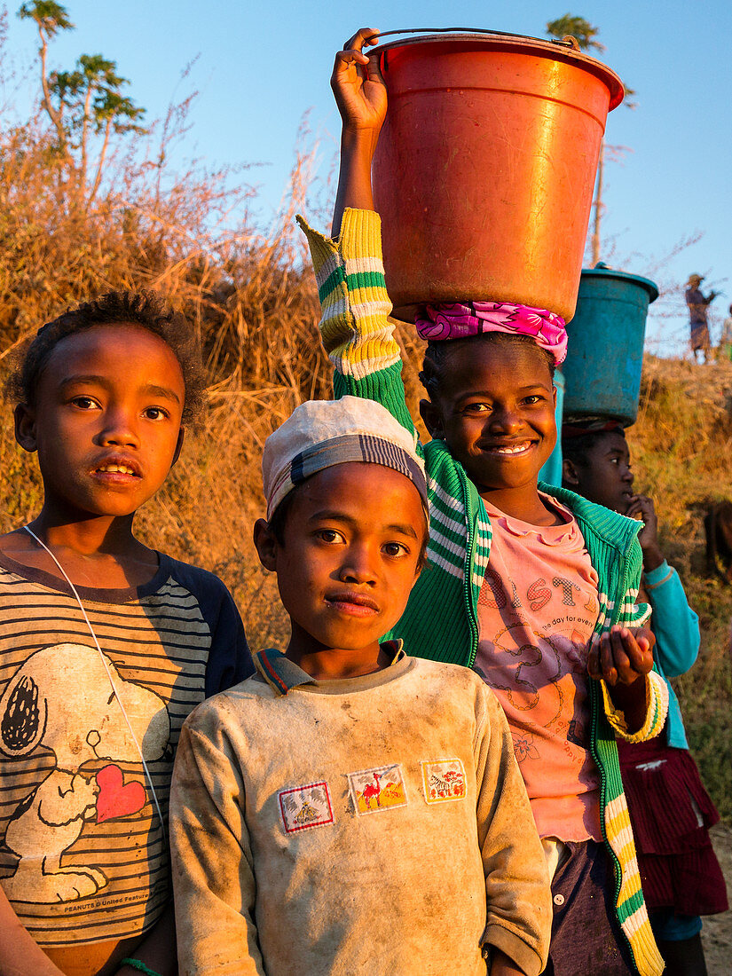 Children come from fetching water, at Ampefy, Merina tribe, highlands, Madagascar, Africa