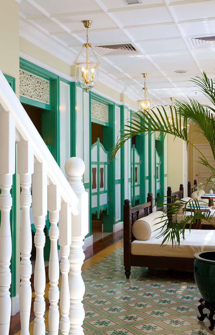 Interior view of a spa, treatment room in faded green colors and decorative floor tiles. Malacca, Malaysia.