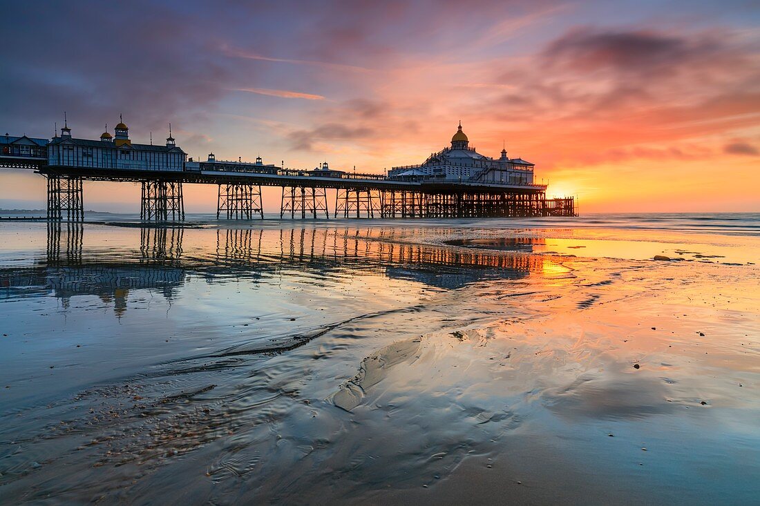 Sunrise captured from Eastbourne Beach at low tide in early March with the pier in the distance.  A two second shutter speed was utilized to subtlely blur the movement in the fast moving clouds and water.