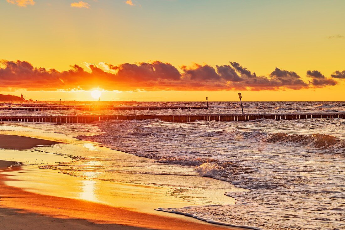 Sunset at the beach of the Baltic Sea in Kolobrzeg, Western Pomerania, Poland, Europe