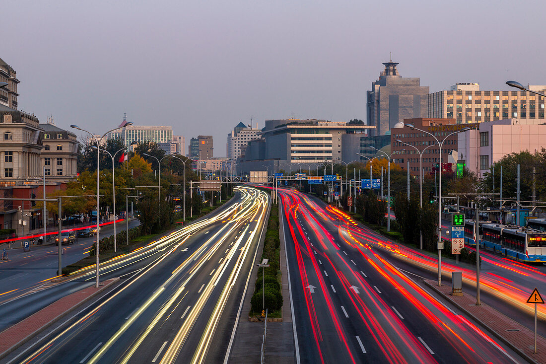 Traffic trail lights on major road near Beijing Zoo at dusk, Beijing, People's Republic of China, Asia