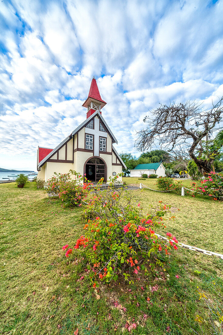 Clouds over the red roof of Notre Dame Auxiliatrice Church, Cap Malheureux, Mauritius, Indian Ocean, Africa