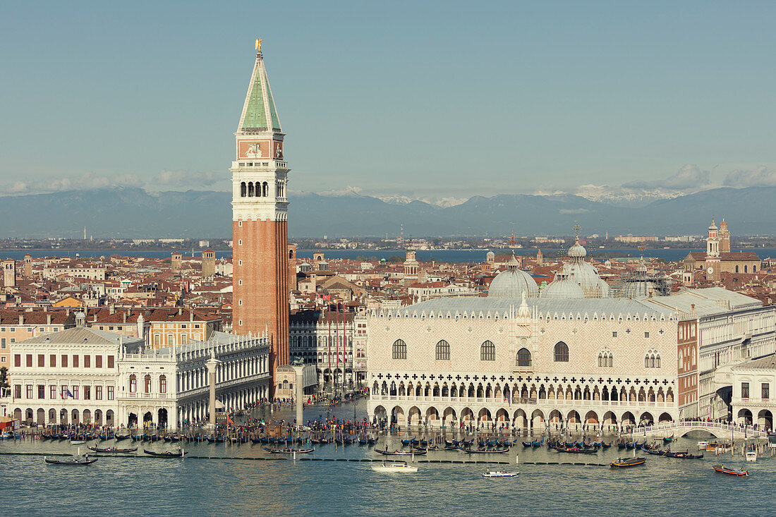 The Doge's Palace, Campanile, Bridge of Sighs and a flooded St. Mark's Square with gondolas lining the shore and Alps beyond, Venice, UNESCO World Heritage Site, Veneto, Italy, Europe