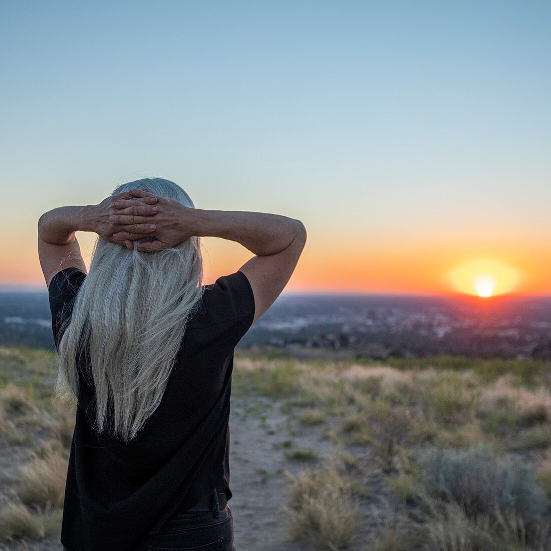 USA, Idaho, Boise, Woman looking at sunset