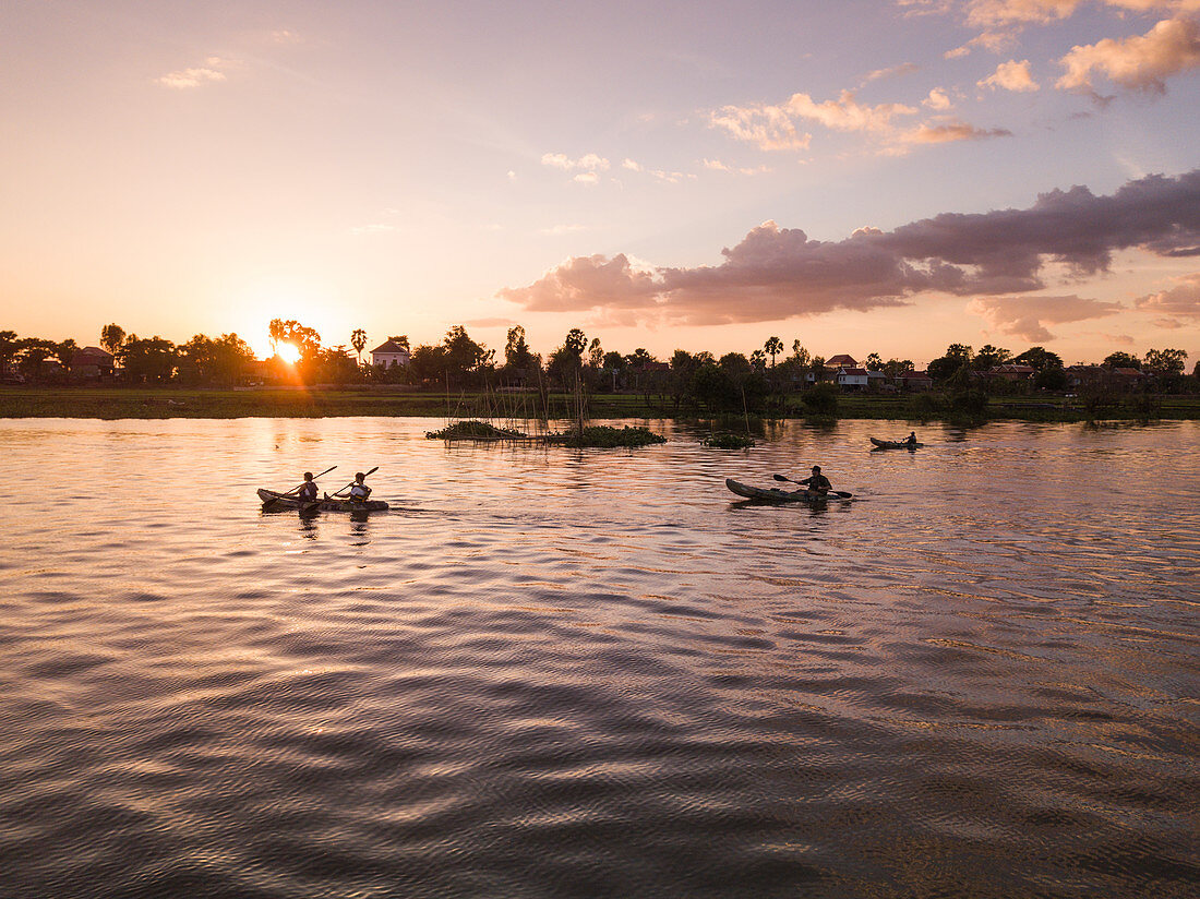 Aerial view kayak excursion for guests of river cruise ship on Tonle Sap River at sunset, Kampong Prasat, Kampong Chhnang, Cambodia, Asia