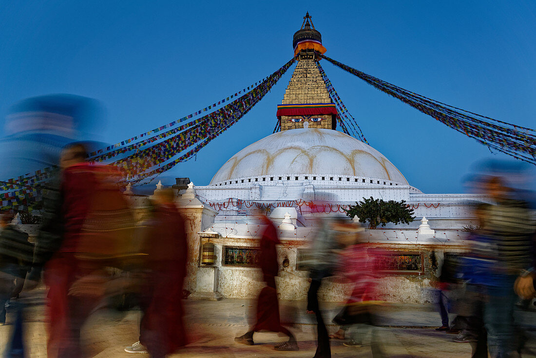 Pilgrims circle the Bodnath Stupa in Bodnath, Kathmandu, Nepal, Asia.