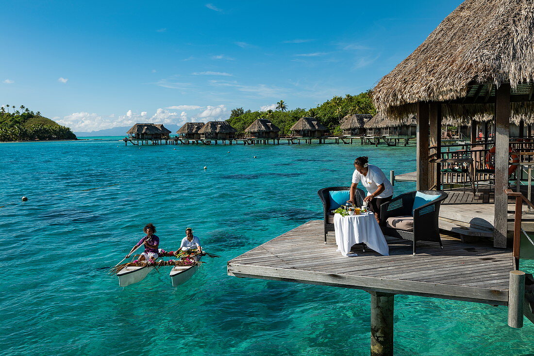 Breakfast is served in a pirogue outrigger canoe to an overwater bungalow at Sofitel Bora Bora Private Island Resort in Bora Bora Lagoon, Bora Bora, Leeward Islands, French Polynesia, South Pacific