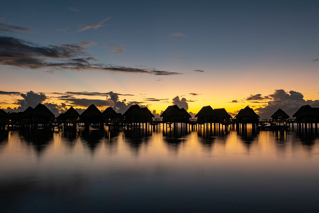 Overwater bungalows of the Sofitel Ia Ora Beach Resort in the Moorea Lagoon at daybreak, Moorea, Windward Islands, French Polynesia, South Pacific