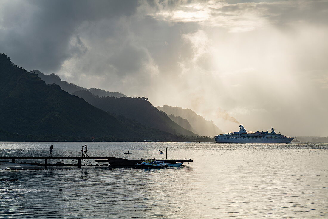 Cruise ship leaves Opunohu Bay during a thunderstorm, Moorea, Windward Islands, French Polynesia, South Pacific