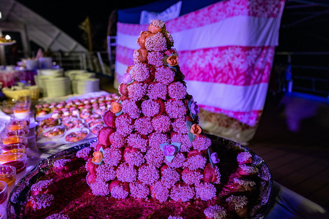 Cake for dessert at the Polynesian evening with a rich buffet and cultural entertainment on board the passenger cargo ship Aranui 5 (Aranui Cruises), at sea near the Marquesas Islands, French Polynesia, South Pacific