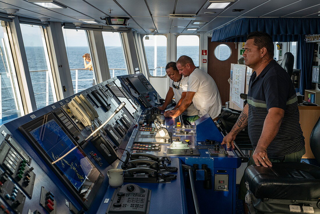 Captain Christophe Dupuy and officers on the bridge of the passenger cargo ship Aranui 5 (Aranui Cruises), Hakahau, Ua Pou, Marquesas Islands, French Polynesia, South Pacific