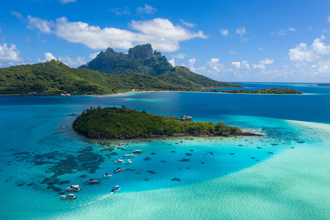 Excursion boats in the Bora Bora lagoon with Sofitel Bora Bora Private Island Resort and Mount Otemanu in the distance, Bora Bora, Leeward Islands, French Polynesia, South Pacific