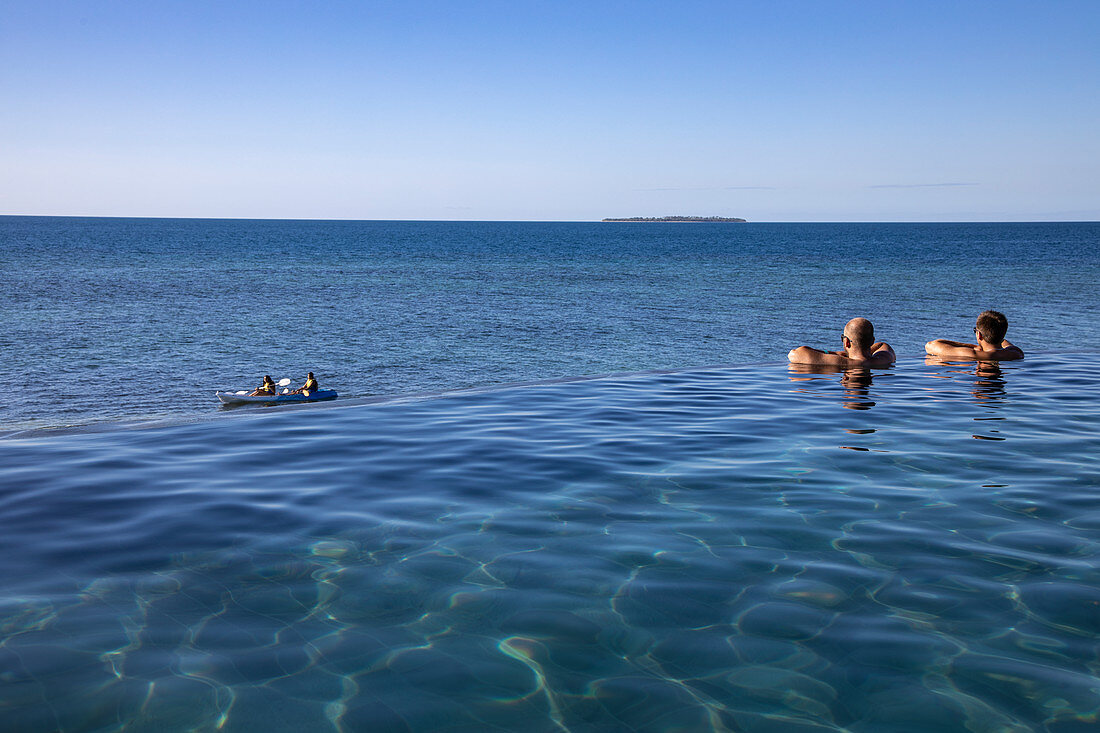People relaxing in the infinity pool at Malamala Island Beach Club, Mala Mala Island, Mamanuca Group, Fiji Islands, South Pacific
