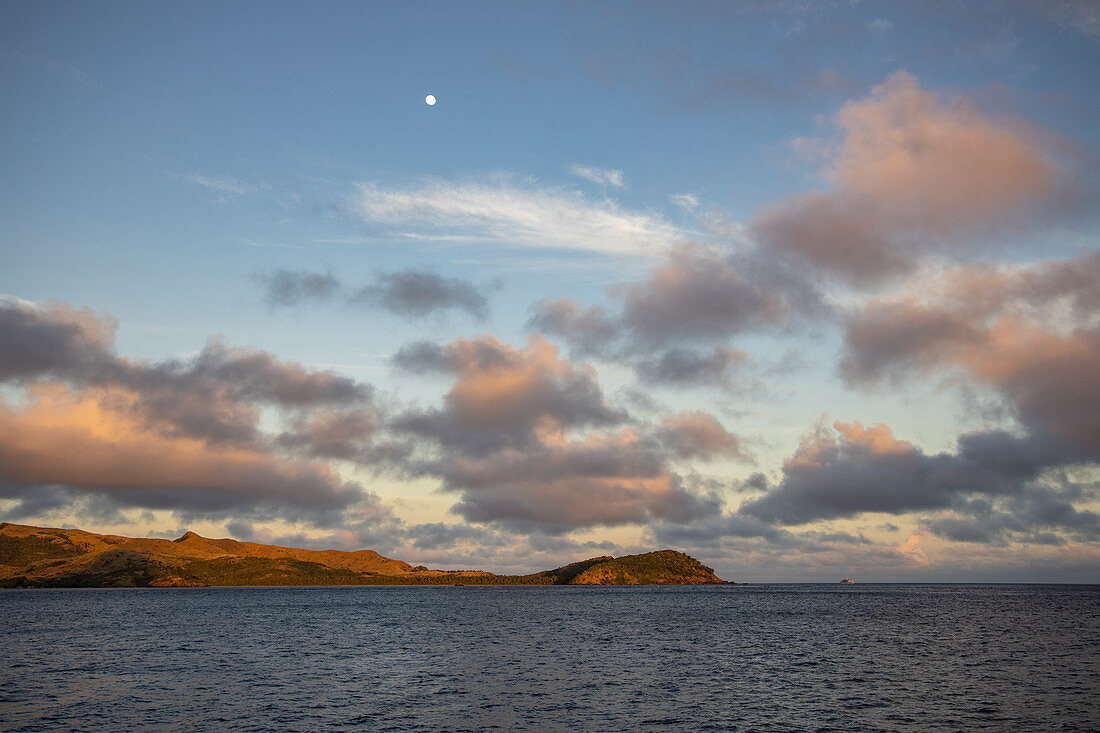Wolken und Mond über Insel bei Sonnenaufgang, Sawa-i-Lau Island, Yasawa Group, Fidschi-Inseln, Südpazifik