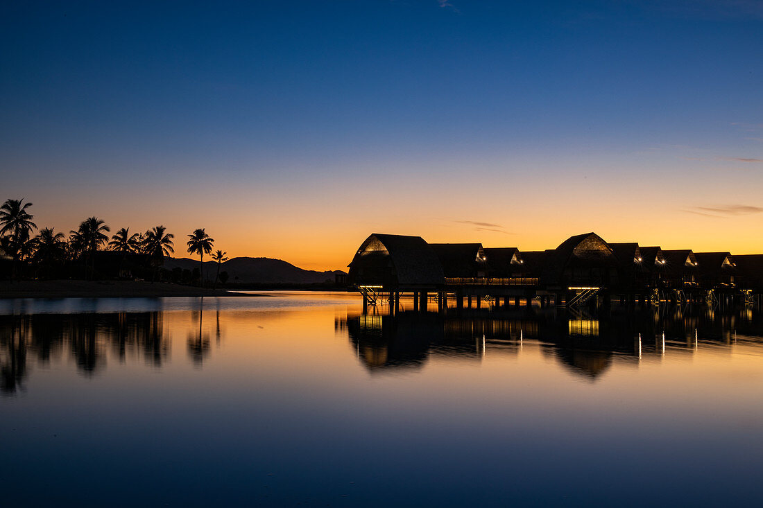 Silhouette of overwater bungalows at the Fiji Marriott Resort Momi Bay at daybreak, Momi Bay, Coral Coast, Viti Levu, Fiji Islands, South Pacific