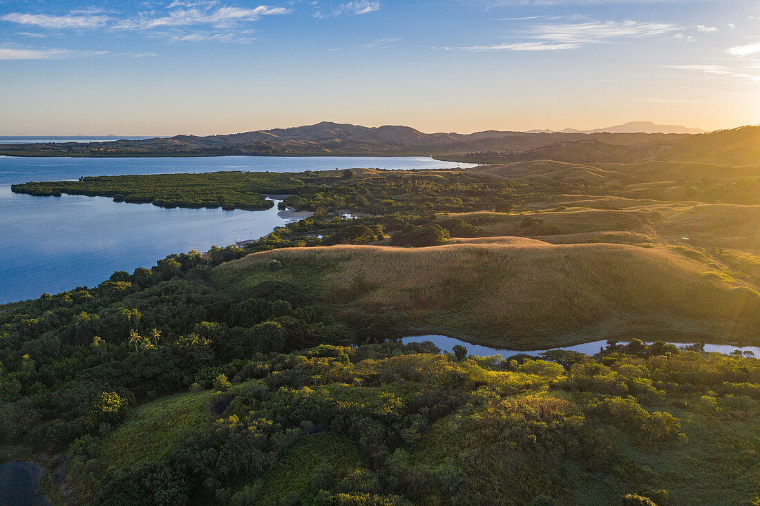 Aerial view of lush hills and coastline at sunrise, Momi Bay, Coral Coast, Viti Levu, Fiji Islands, South Pacific