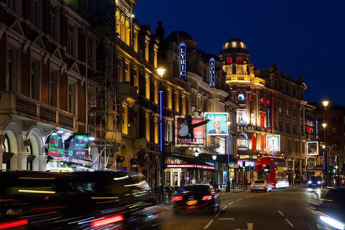 An eveing shot of traffic and neon lights in Shaftesbury Avenue in London, UK.