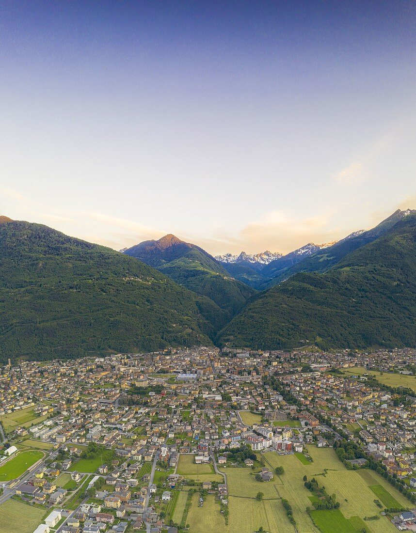 Cultivated fields around Morbegno and Orobie Alps at sunset, aerial view, Valtellina, Sondrio province, Lombardy, Italy
